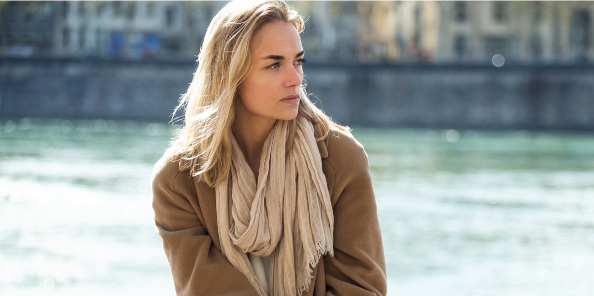 woman sitting in front of river 