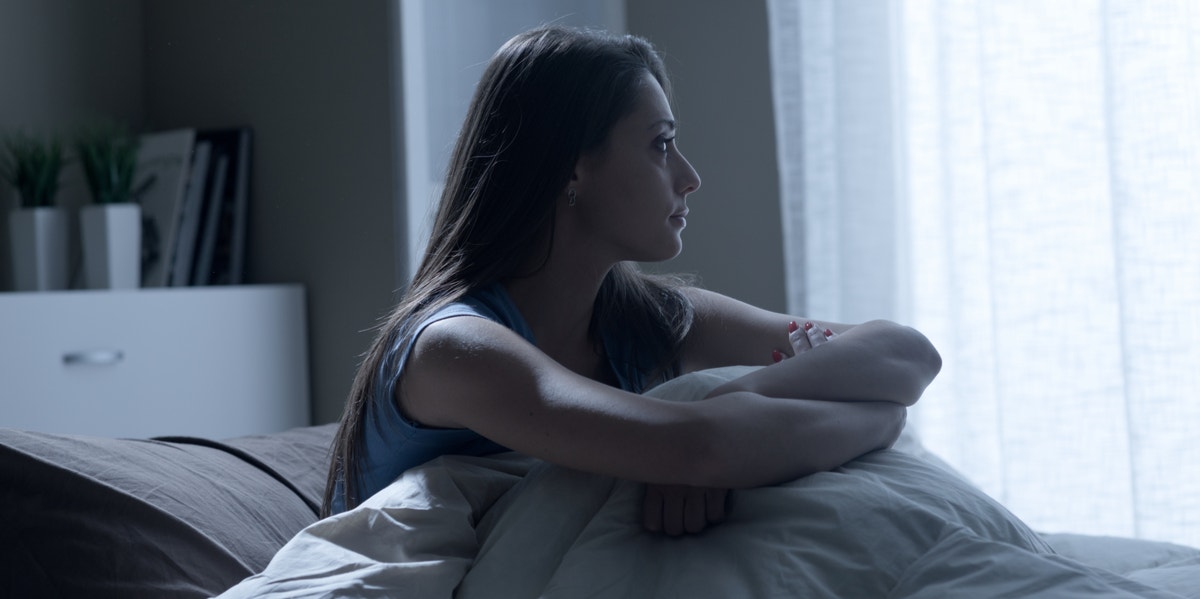 How Witnessing Domestic Violence Taught Me How Truly Common It Is sad woman in bed