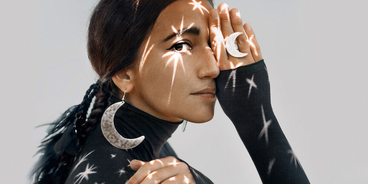 12 Songs About the Moon - Ultimate Lunar Playlist artsy picture of woman with moon earrings