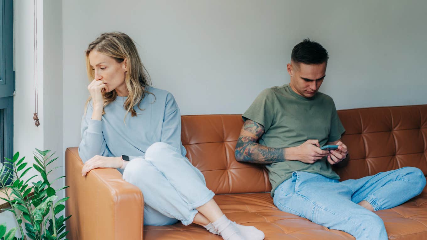 Woman Accuses Her Boyfriend Of Not Loving Her After He Changes His Phone Lock Screen couple on couch disconnected because of technology