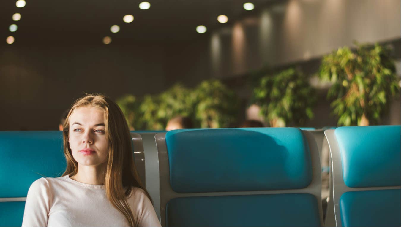 woman sitting in an empty airport 