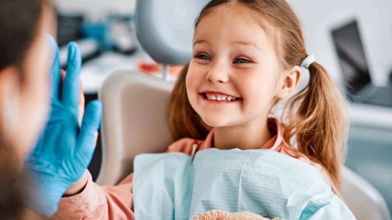 little girl smiling after a cleaning at dentist