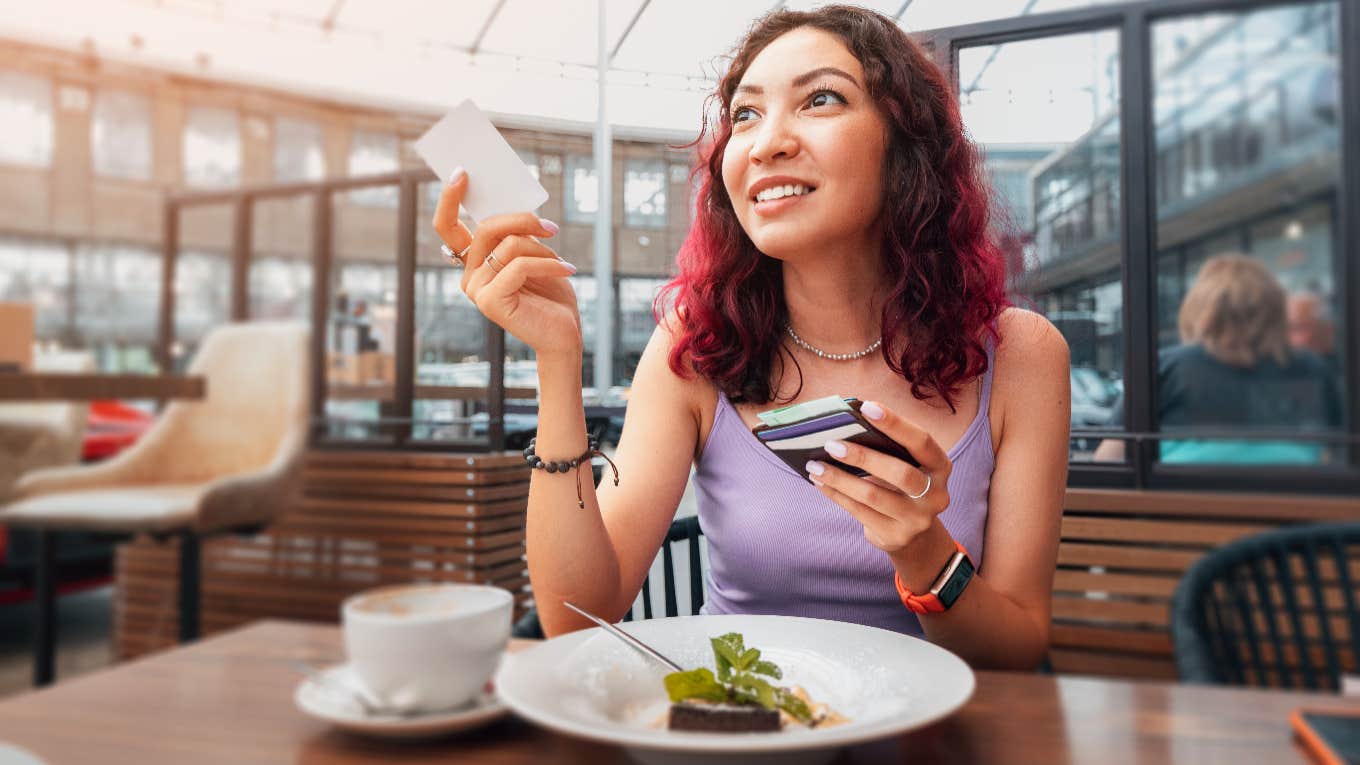 Woman Complains After She Was Charged A 5% Employee Health Fee On Restaurant Bill In Addition To Her Tip woman about to pay her bill