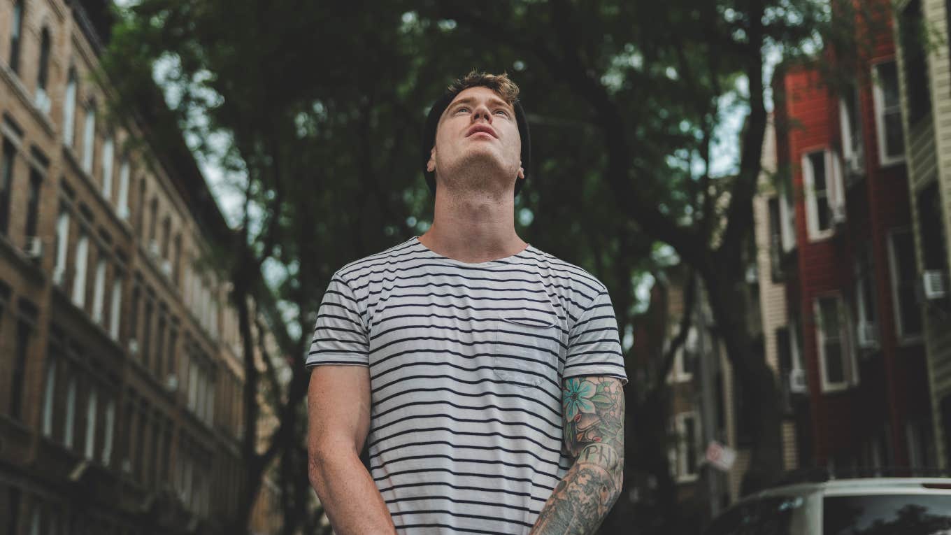 tattooed man looking up