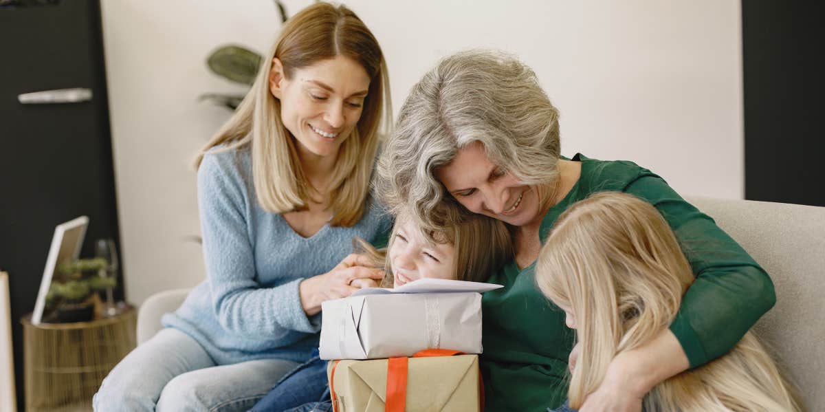 Woman and grandmother sitting on couch with children