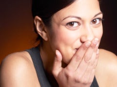 woman covering mouth after a mistake