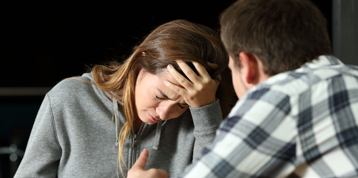 woman crying in front of man