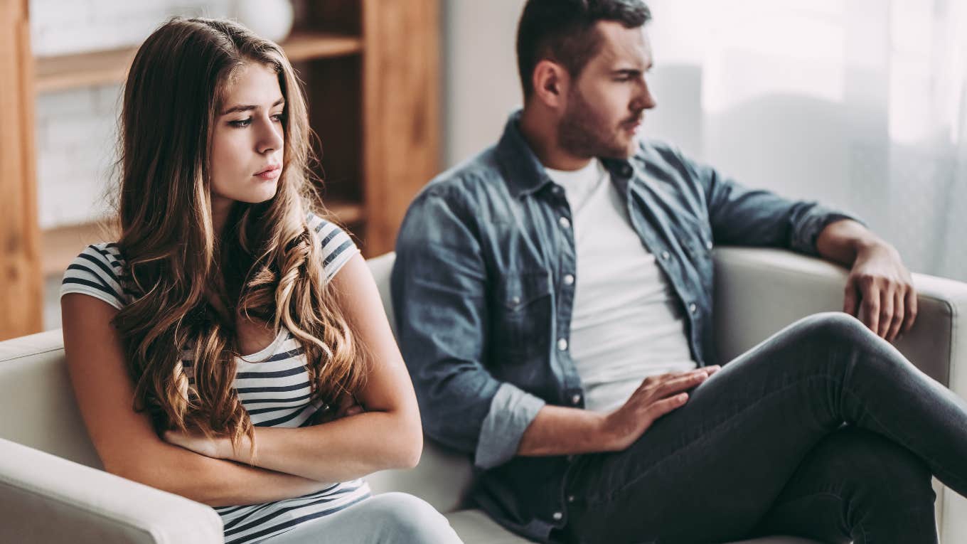 Woman Says She's Dating A Broke Guy With A Great Personality But Won't Stay With Him Until He Starts Making More Money upset couple sitting with their backs turned on a couch