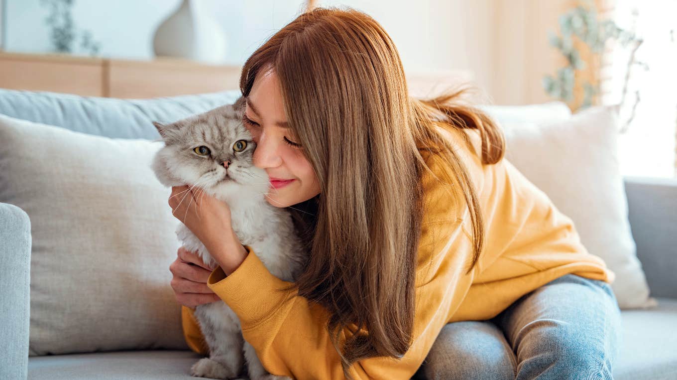 woman hugging her cat