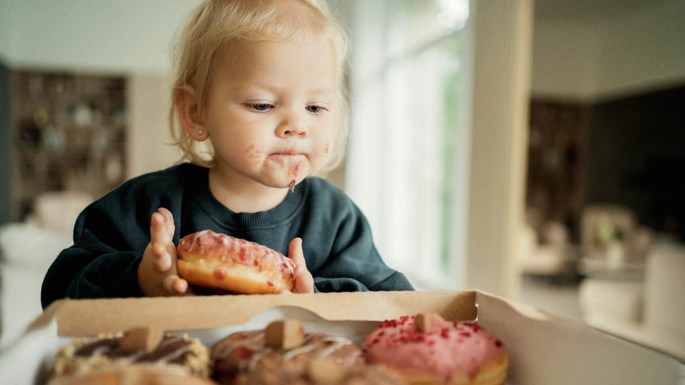 little kid eating donuts