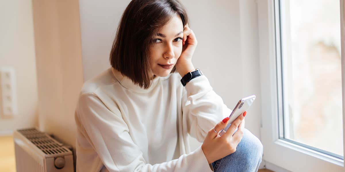 woman deleting photos of herself from phone