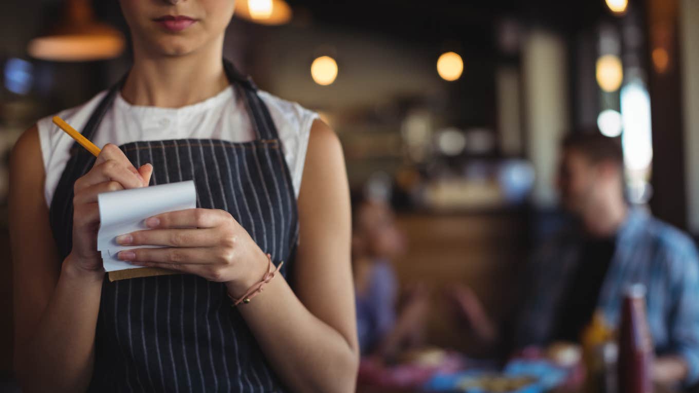 waitress writing in notepad