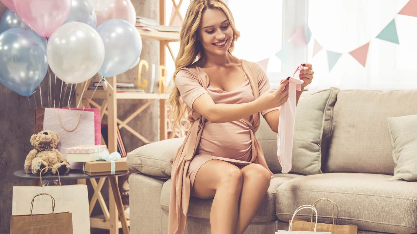 pregnant woman opening baby gifts