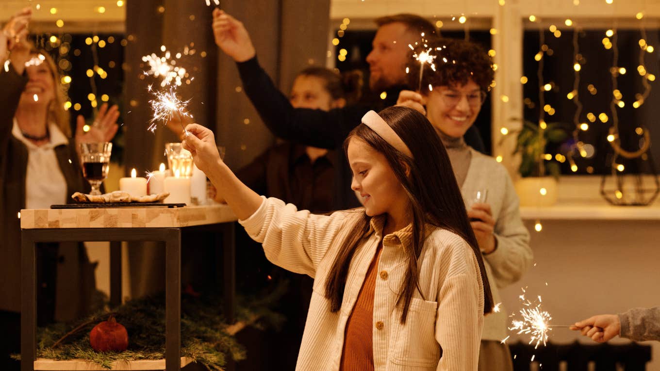 family holding sparklers at christmas 