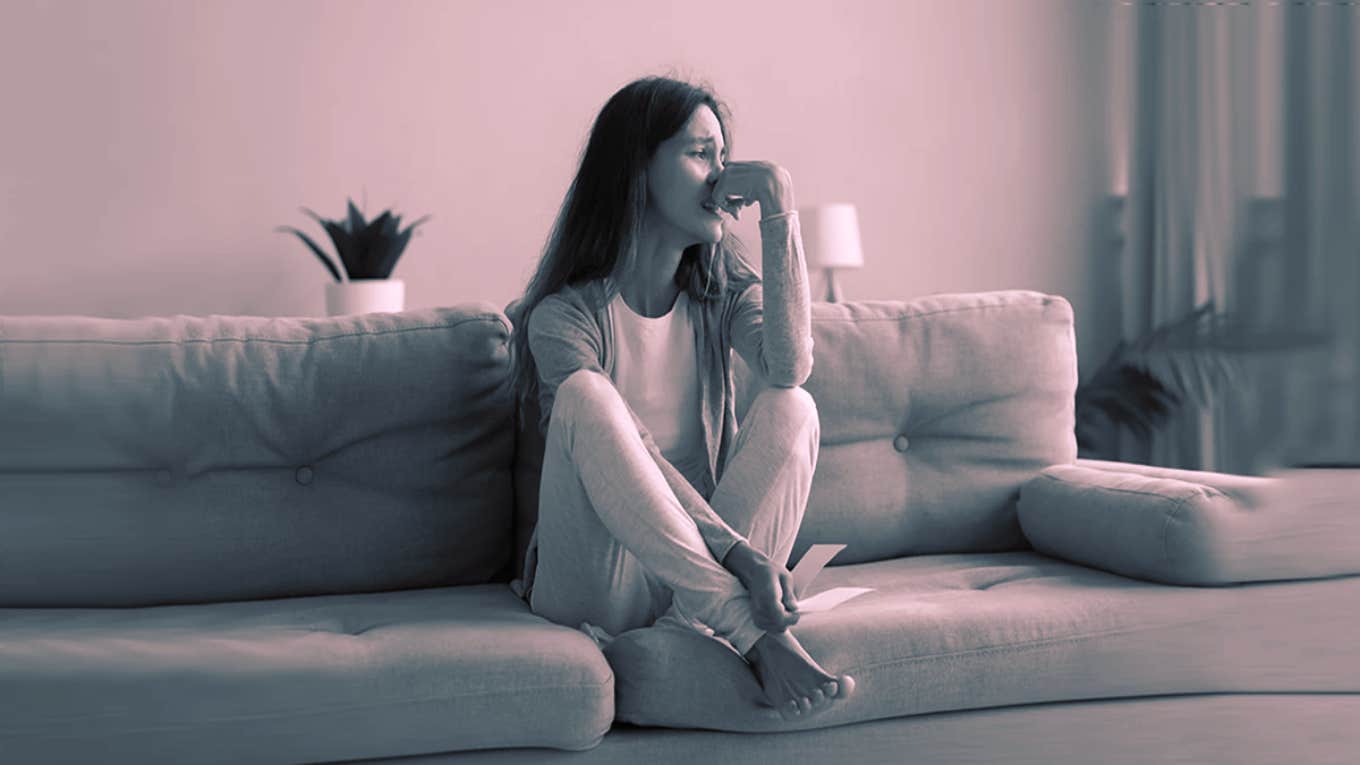 Woman Leaves Her Boyfriend Despite Him Investing In Her And Boosting Her Self-Esteem sad woman on couch