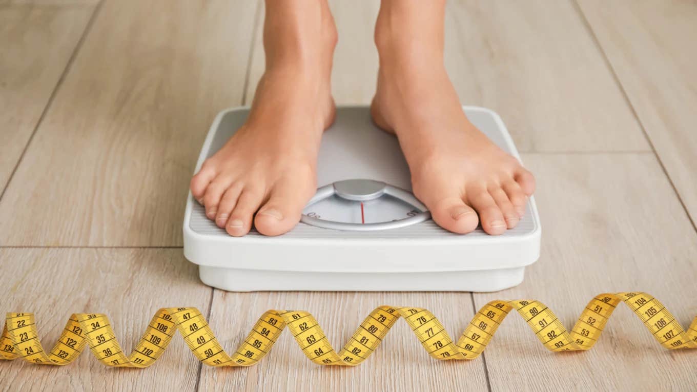 Woman Embarrassed About How She Lost 45 Pounds Keeps Lying To Her Friends And Family woman on scale, weight loss