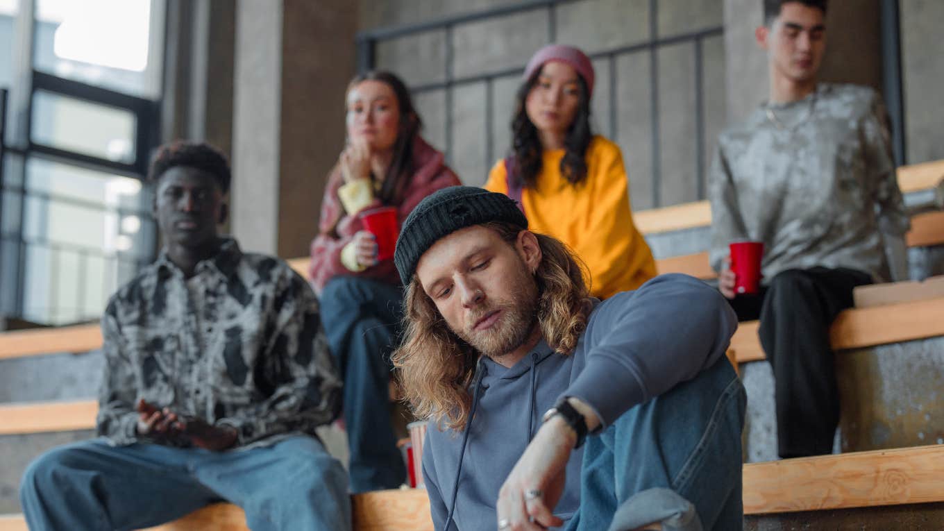 group of young people sitting on stairs 