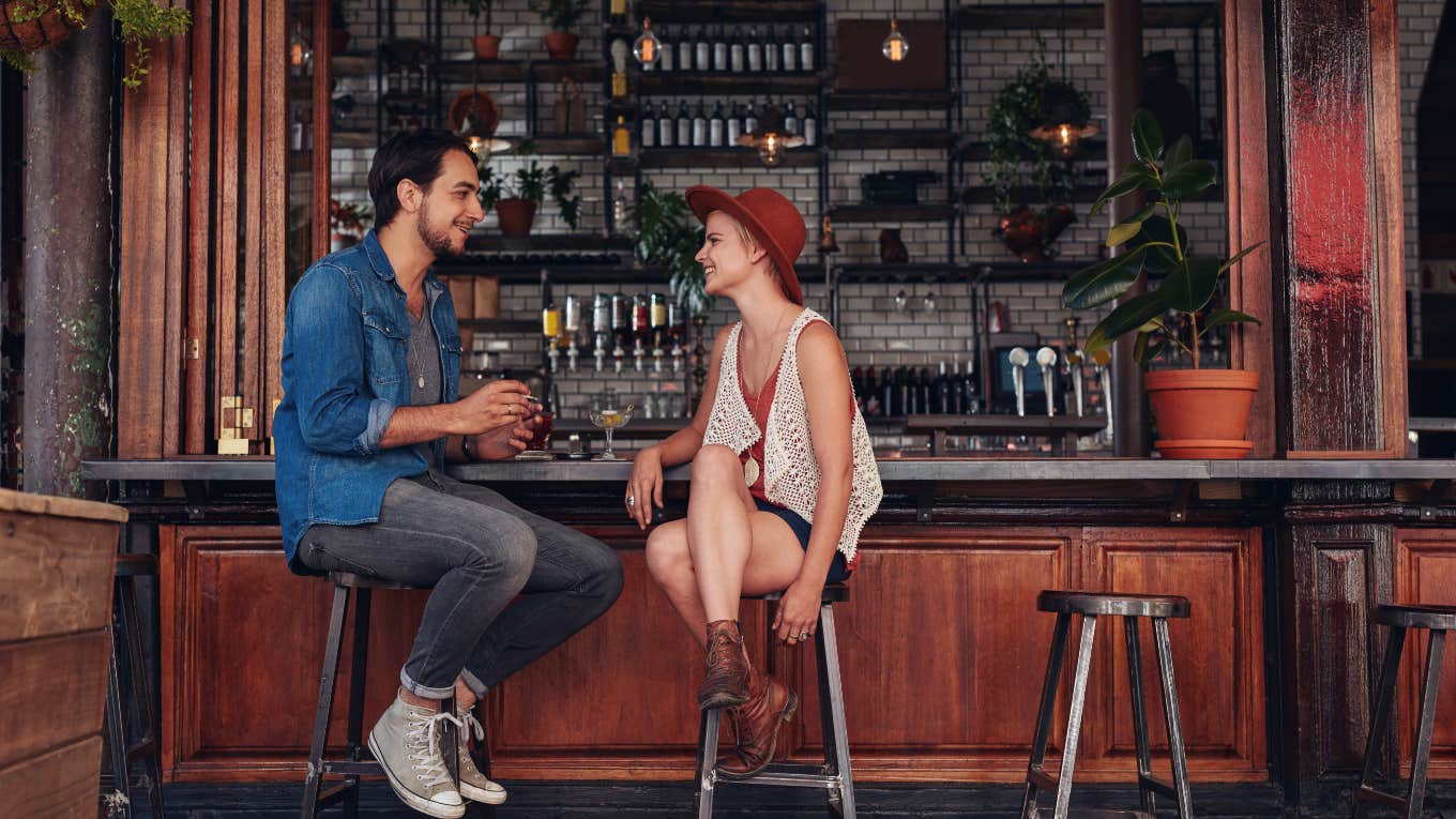 man and woman sitting at cafe counter