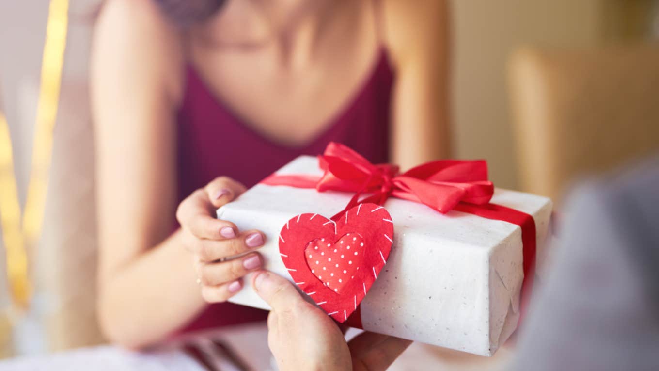 man handing a valentine's day gift to a woman