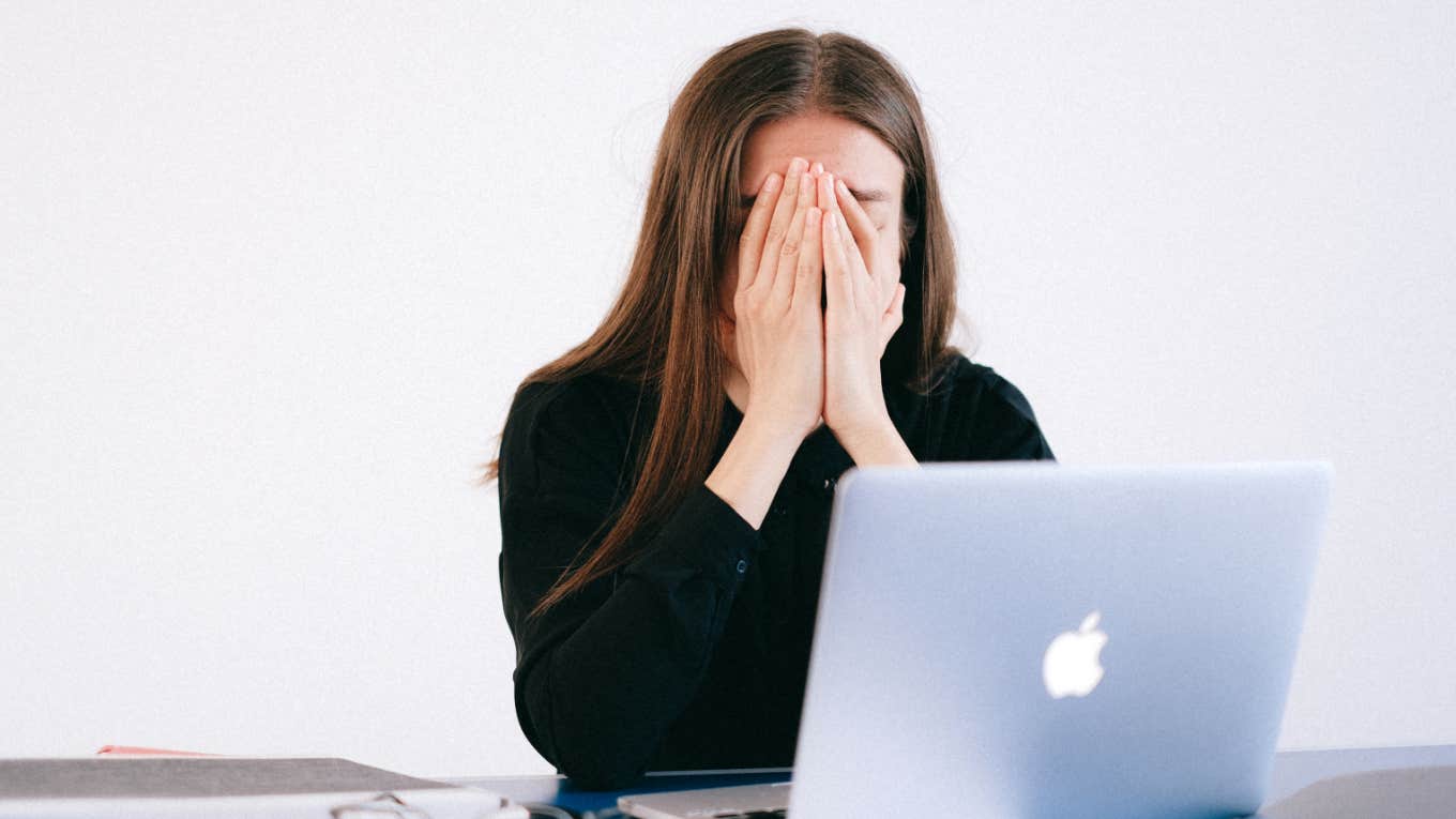 A young woman films herself being fired from work over Zoom by a man she has never met