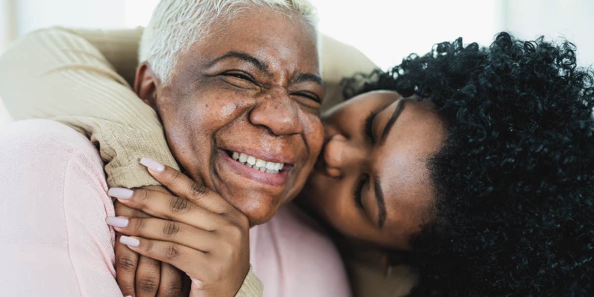 Woman kissing mom on cheek