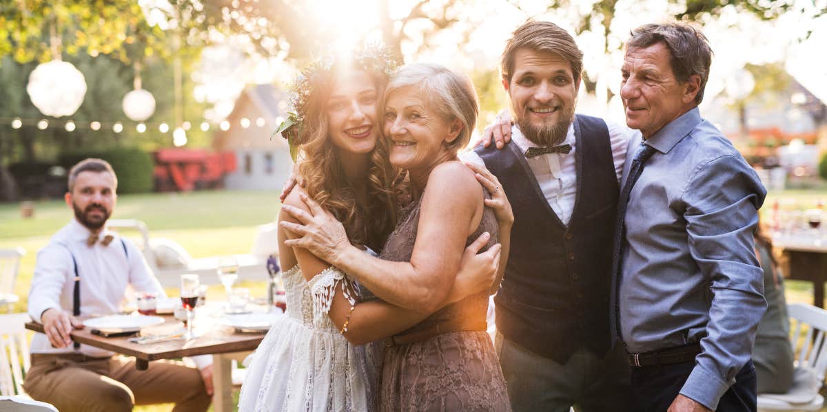Woman Has Second Thoughts About Marrying Her Boyfriend Because Of His Overbearing Mother Couple at their wedding with their parents