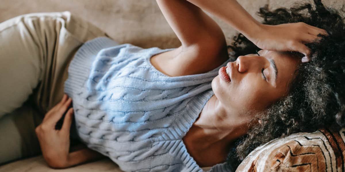 Woman Says Boss Showed Up At Her Home To 'Prove' That She Wasn't Sick Woman lying down with headache