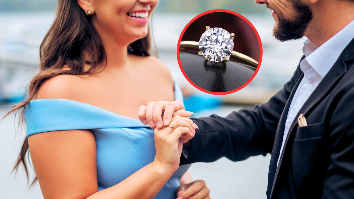 Man putting ring on woman's hand