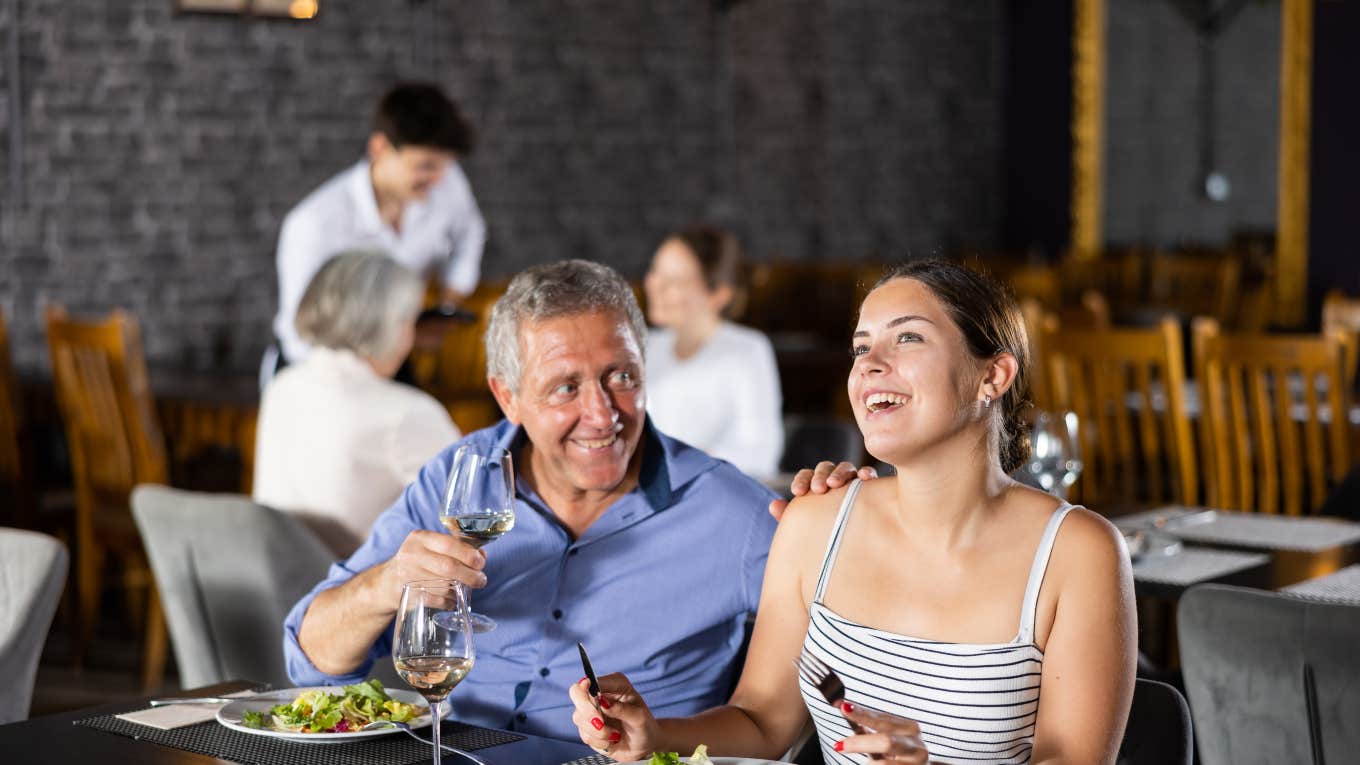 older man and woman eating at a restaurant 