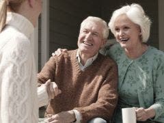 woman shaking hands with elderly couple