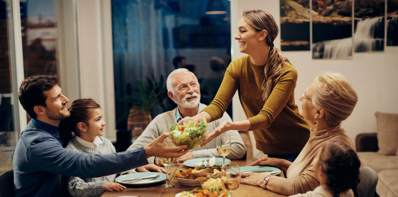 woman serving dinner to her family