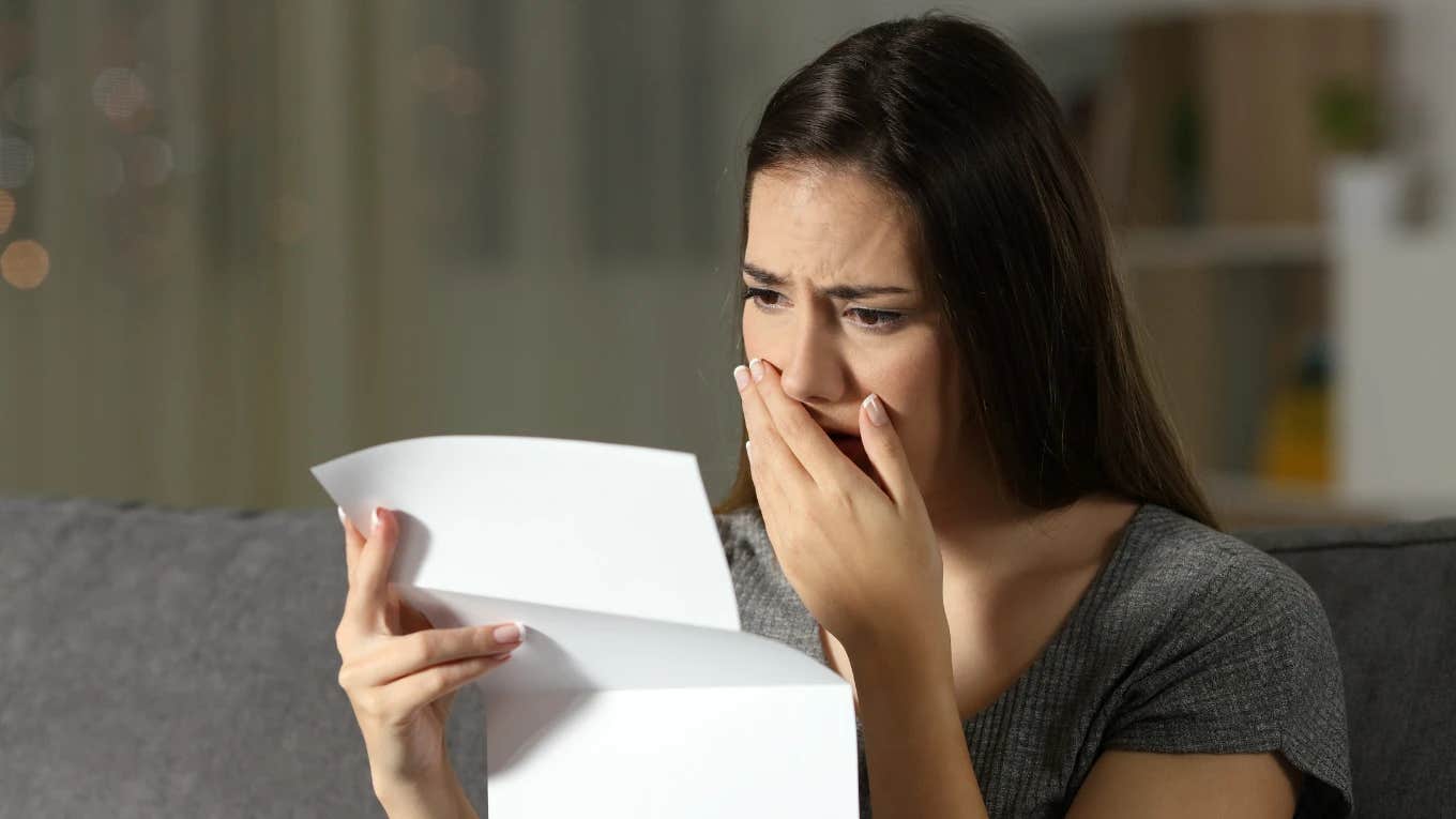 shocked woman reading paper