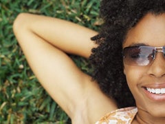 6 Ways To Beat The Summertime Blues woman lying on the grass