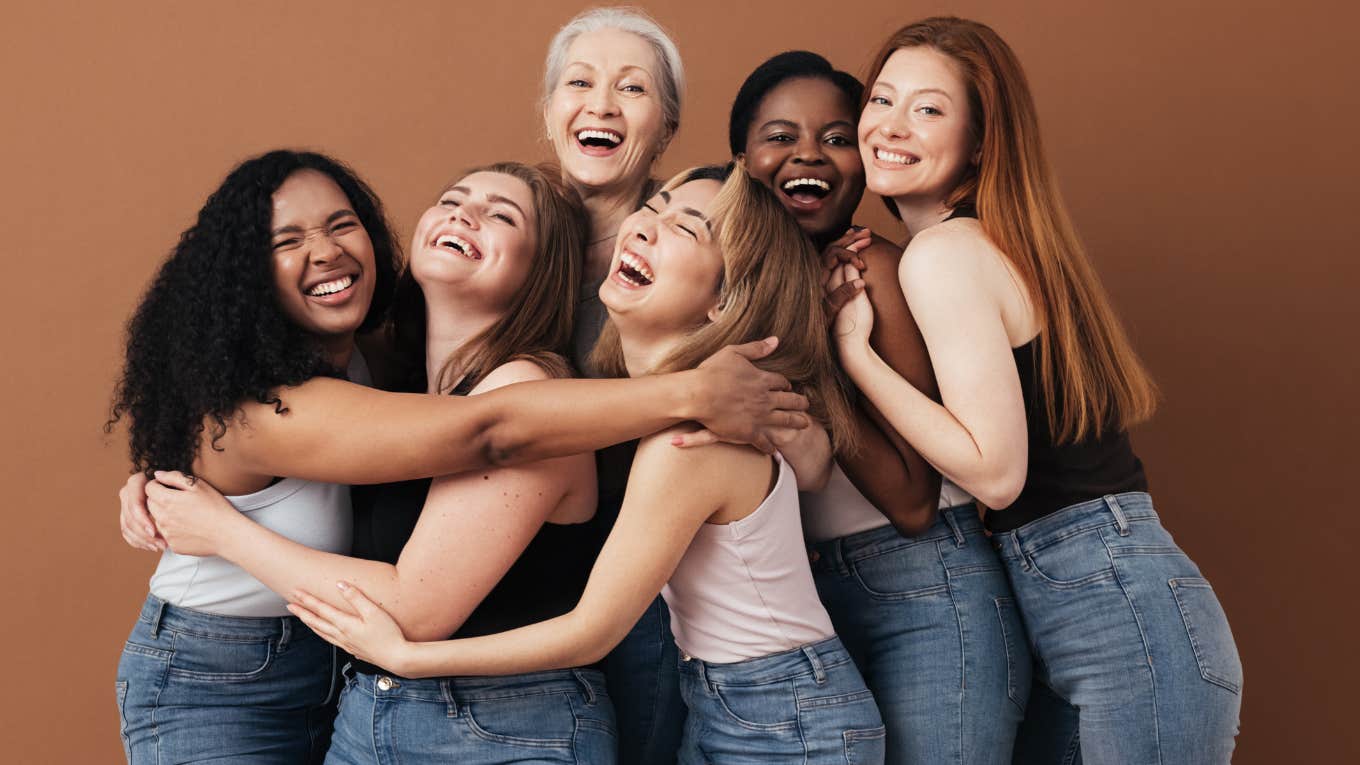 group of women laughing and hugging