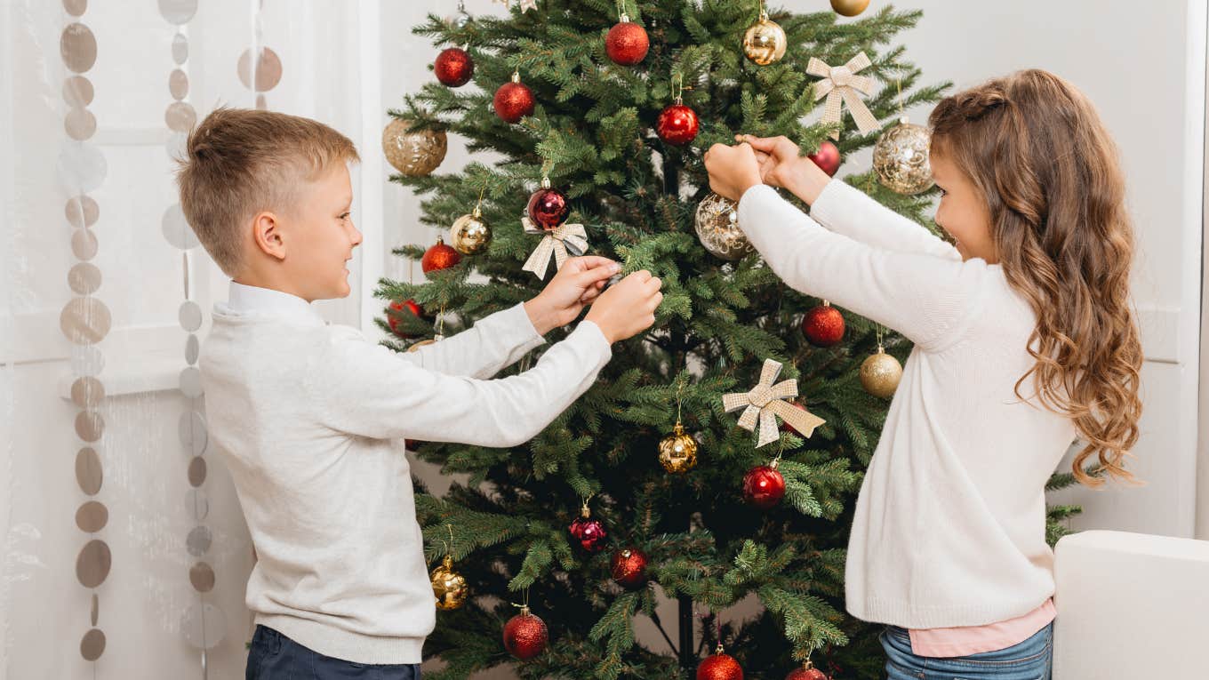 young boy and girl decorating Christmas tree