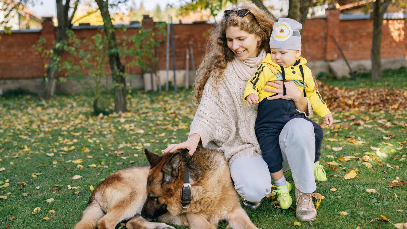 mom, child and dog in a yard