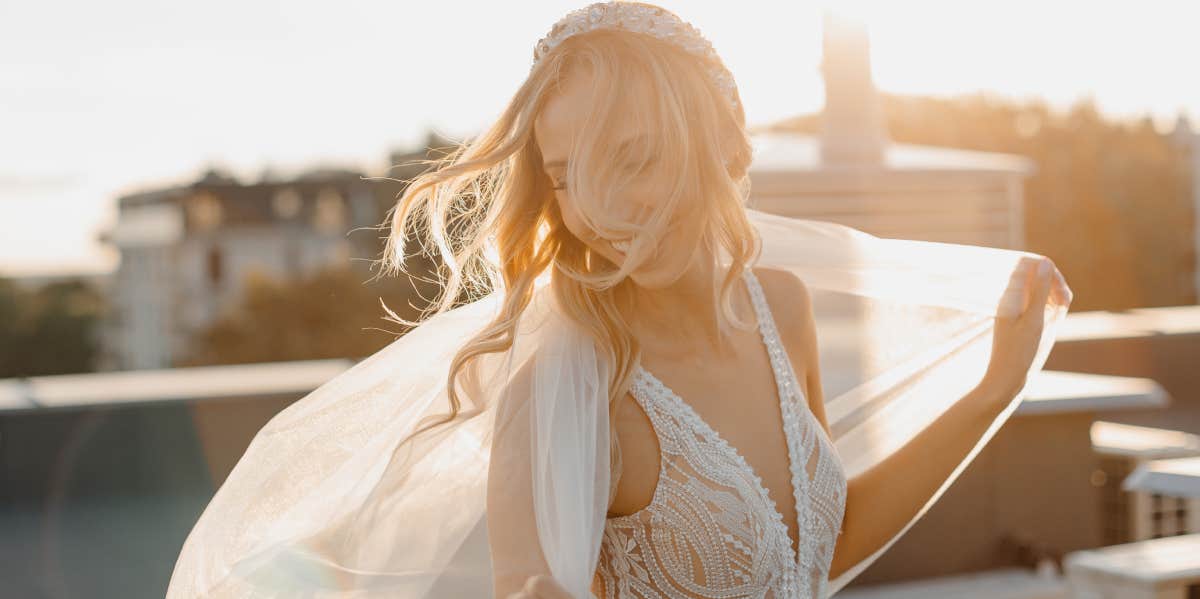 woman posing in wedding dress and bridal veil