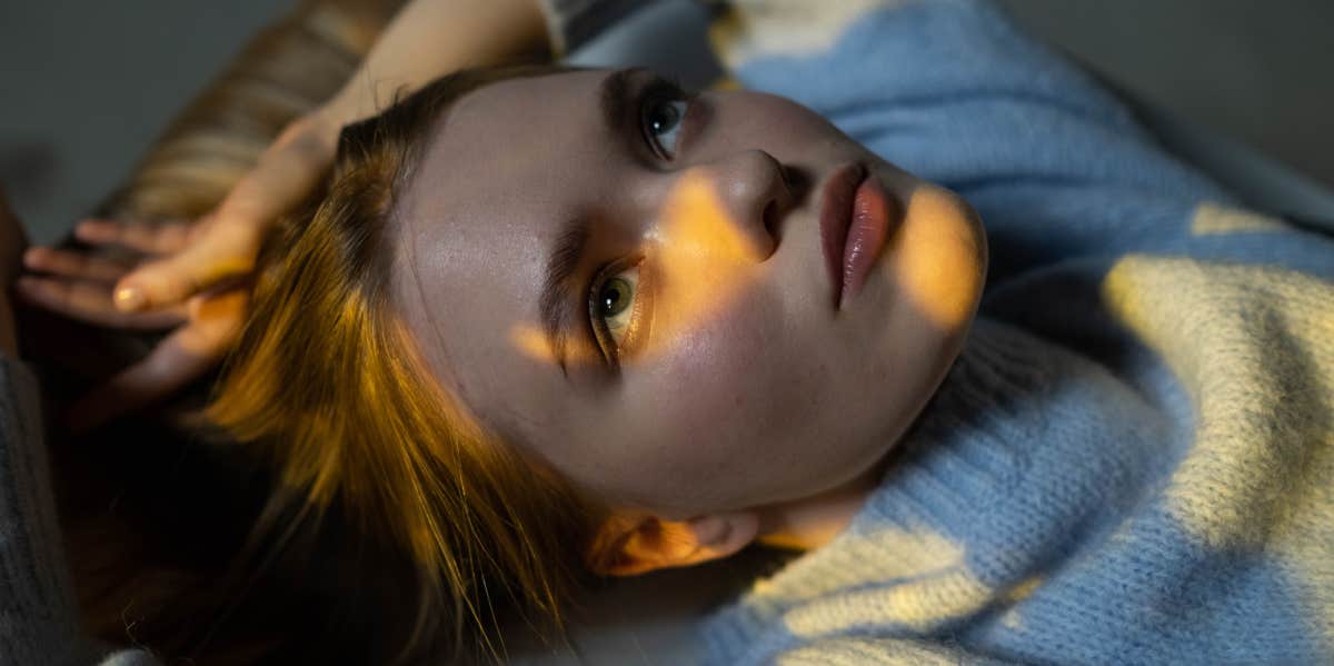 woman thinking while laying in bed