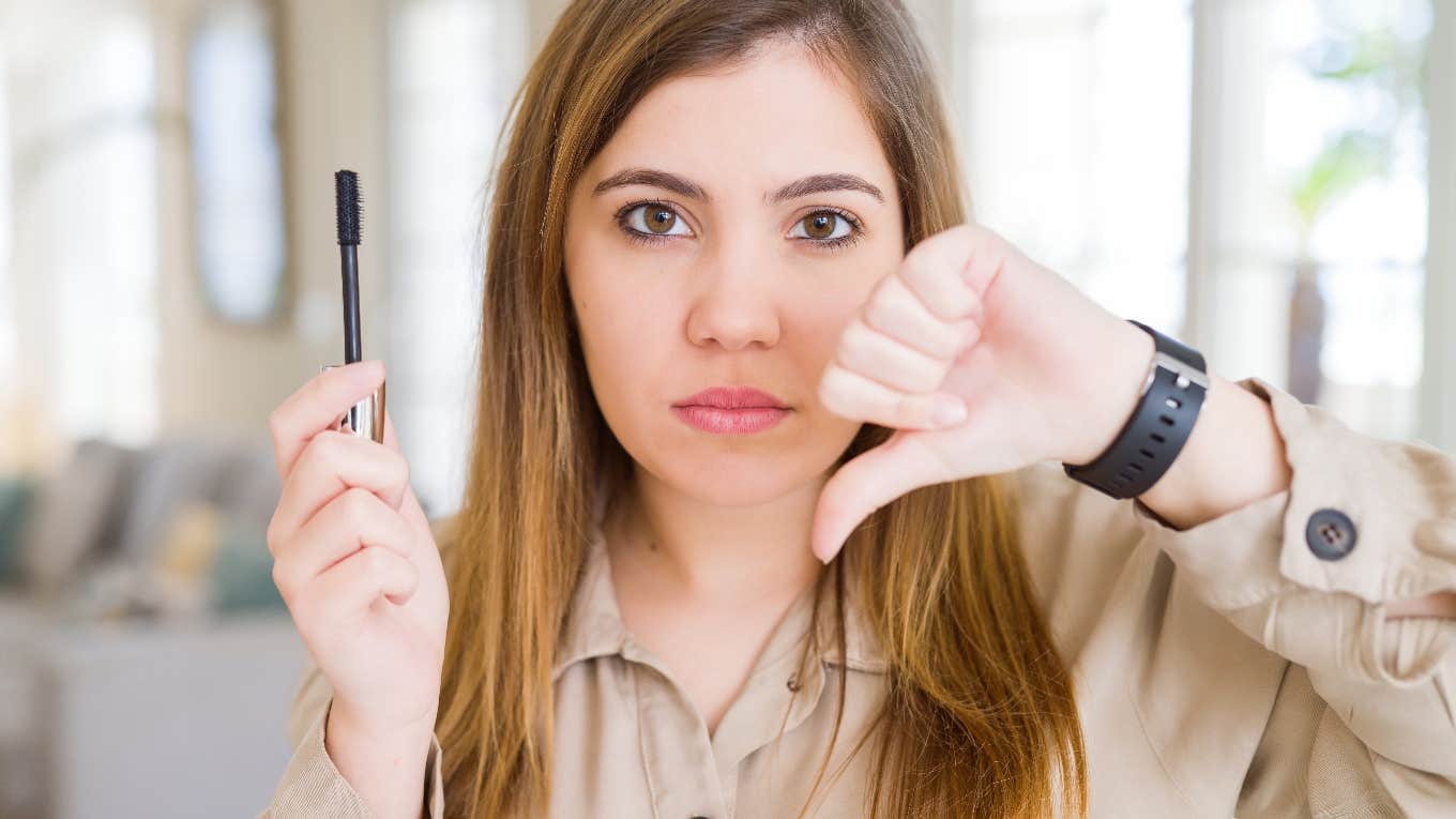 woman unhappy wearing makeup