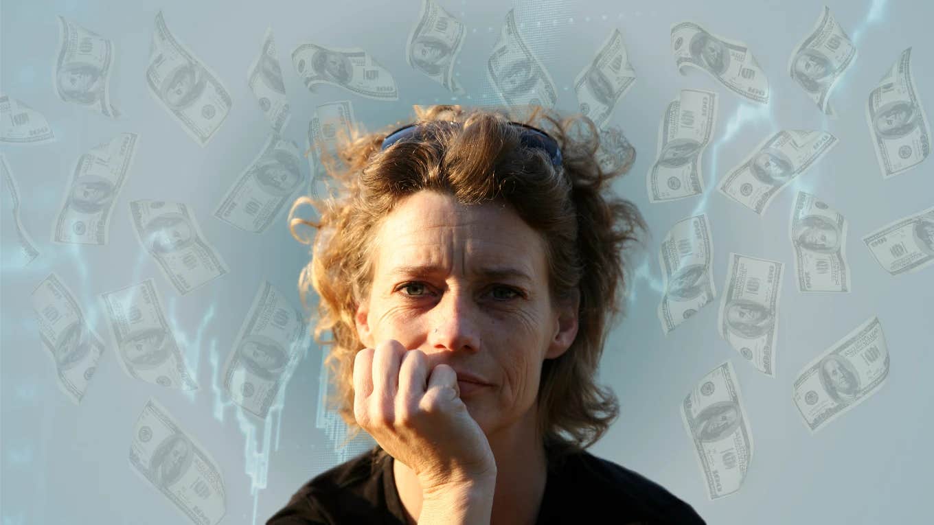 Woman looking tired in front of money background