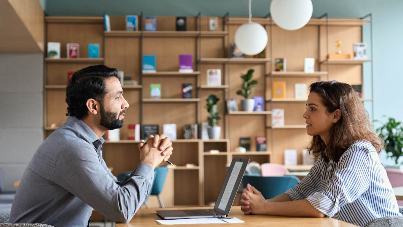 employee and boss having conversation across table