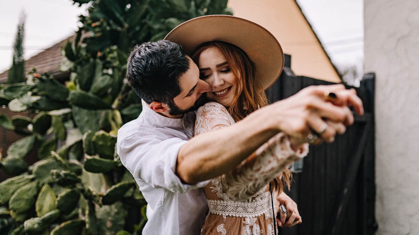 Woman Says Daddy Energy Is The Most Attractive Trait A Man Can Have couple dancing smiling together