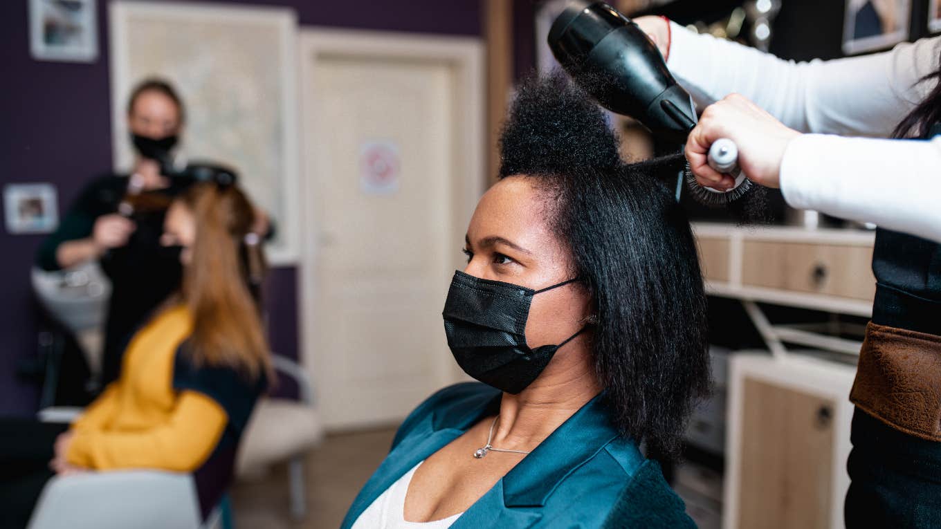 black woman getting hair done in salon