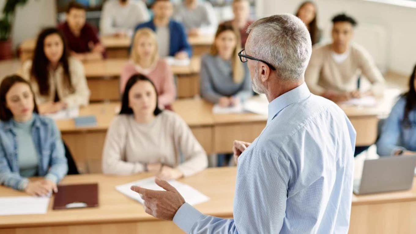 college professor teaching full classroom