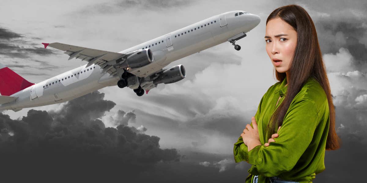 woman standing with arms crossed, plane in sky