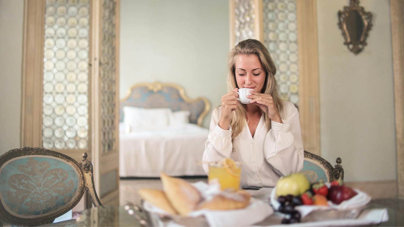 woman eating breakfast at hotel 