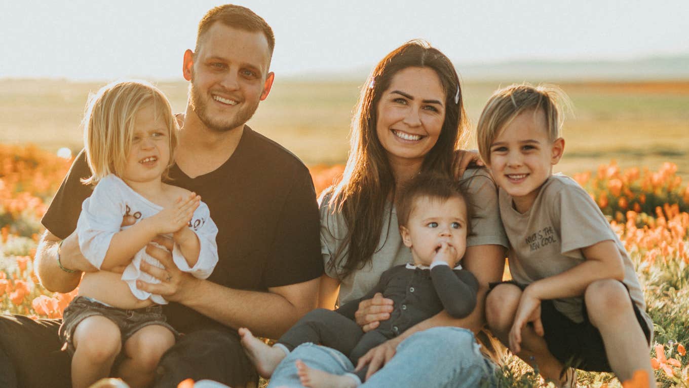 family sitting in a field 