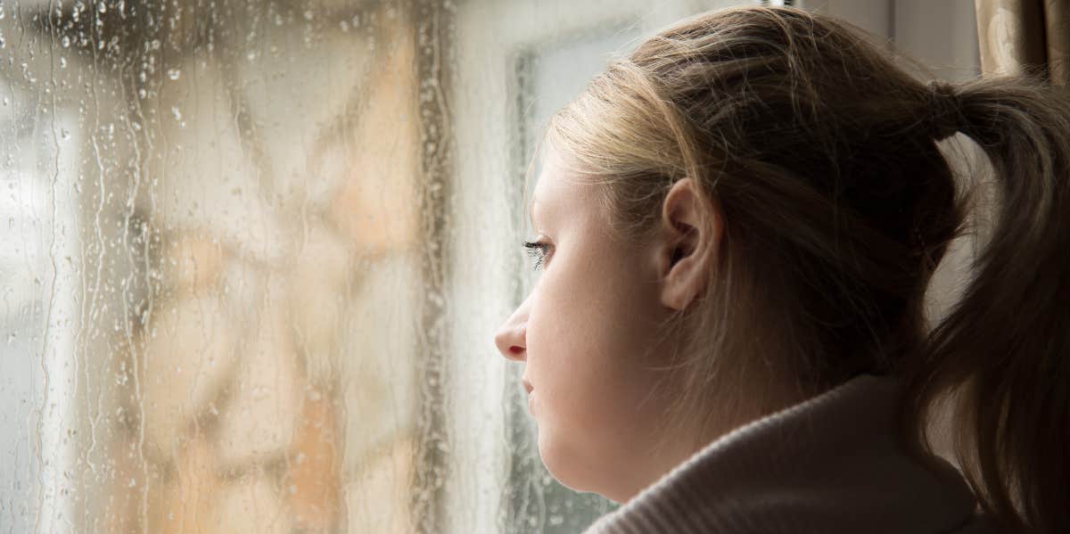 Woman looking out window