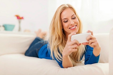 woman smiling and texting