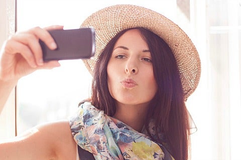 woman taking selfie in hat and scarf
